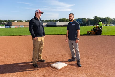 account manager with customer at baseball field